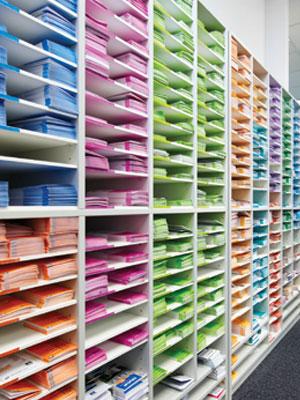 Printed timetables stacked on shelves